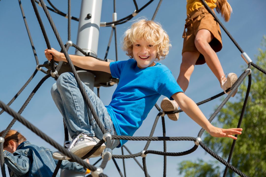 children-climbing-rope-together-close-up