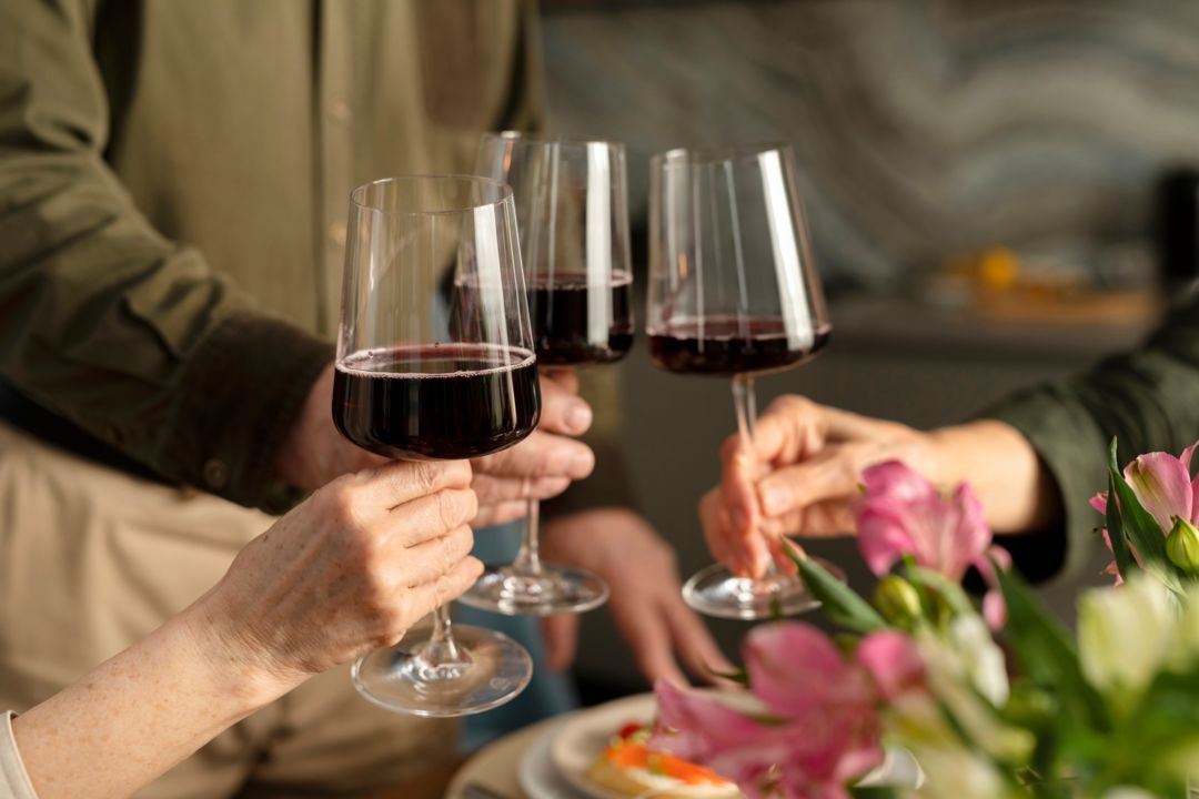 close-up-hands-holding-glasses-with-wine